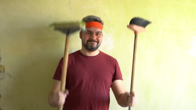 Funny man dancing with a broom