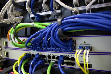 Ethernet cables and fiber optic cable plugged into servers