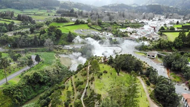 4K aerial footage of the thermal waters in Furnas city at São Miguel Island, Azores, Portugal. Smoke coming of the earth due to the intense vulcanic activities.