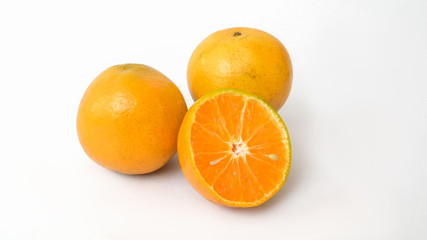 Close up view of half and whole oranges isolated on white background