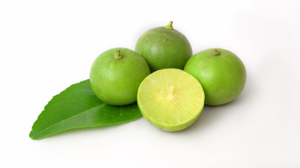 Close up view of half and whole limes isolated on white background