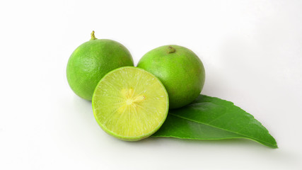 Close up view of limes and leaf isolated on white background