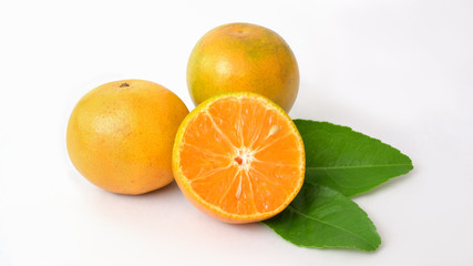 Close up view of oranges and leaves isolated on white background