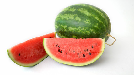 Close up view of whole and sliced ripe watermelon isolated on white background
