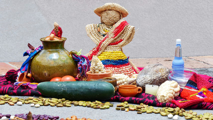 Fragment of Chacana or Ceremony in homage to Pachamama (Mother Earth) is an aboriginal ritual of indigenous peoples of Andes. Different food: beans, corn, tomatoes, cocoa beans, straw doll. Ecuador