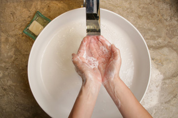 Fototapeta premium Hygiene. Cleaning hands with soap and water. Washing hands on sink. Preventing diseases by washing your hands.