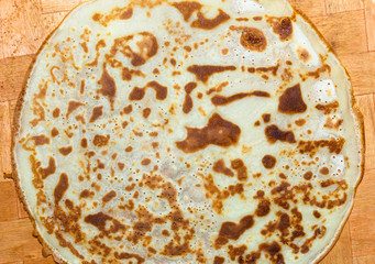Fried pancakes. The texture of the dough. A treat on Shrove Tuesday. Culinary products on a bamboo tray.