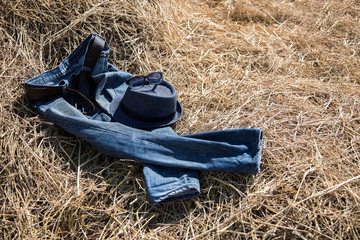 blue jeans on dry straw in cowboy concept with sunny day