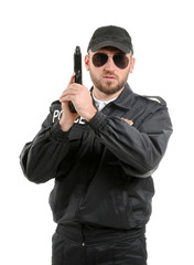 Male police officer with gun on white background