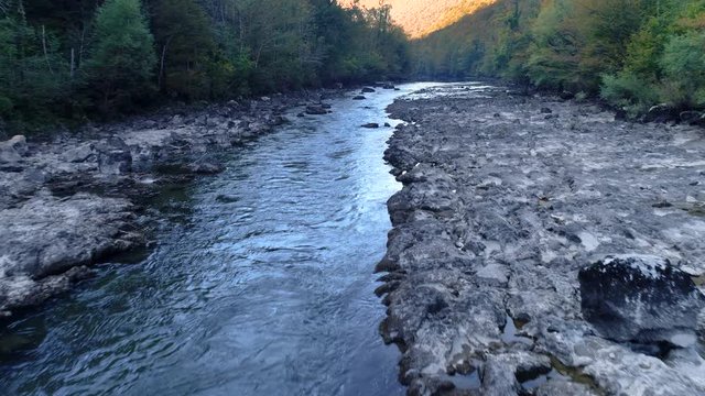 Amazing view of the Kolpa river, Kostel. Stream surrounded by exuberant forest