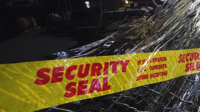 Security sealed packing tape on black plastic