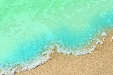 Fototapeta na wymiar Blue Soft wave on sand beach with copy space
