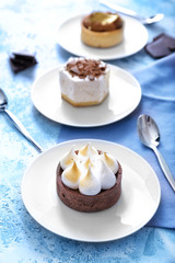 Plate with tasty cake on color background