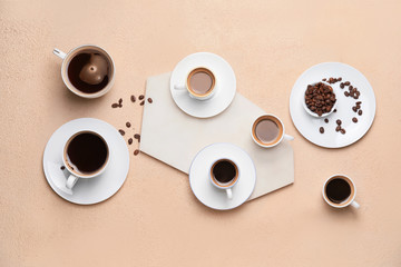 Composition with cups of different coffee on color background