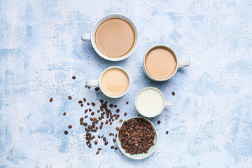 Composition with cups of different coffee on color background