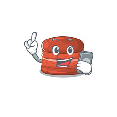 Mascot design of cherry macaron speaking on phone