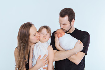 Fototapeta premium the concept of a healthy lifestyle, the protection of children, shopping - baby in the arms of the mother and father. Woman and man holding a child. Isolated on white background. Copy space. Portrait 