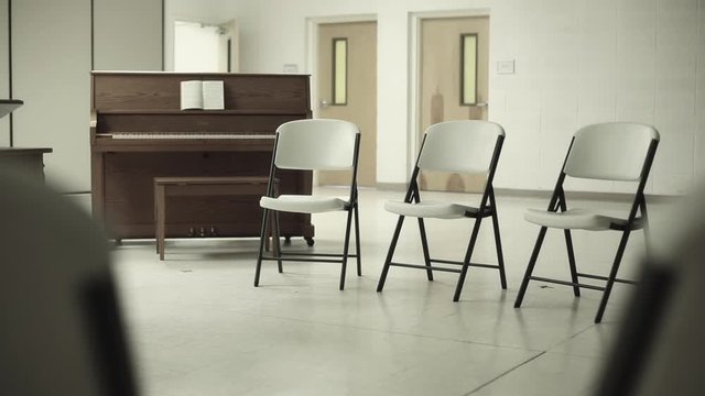 Church Fellowship Hall Chairs Gathered In Circle Around Piano Close Up Tighter