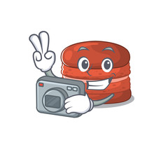 Cherry macaron mascot design as a professional photographer with a camera