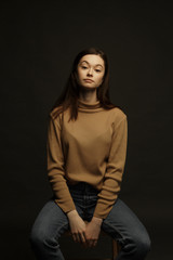 Professional model and posing. Model tests of a girl in a Studio with a black background.