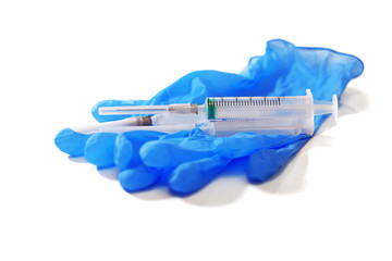 disposable medical gloves and syringe isolated on white background, focus on syringe
