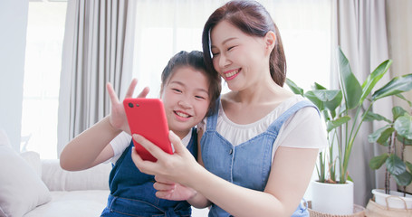 Daughters and mother use smartphone