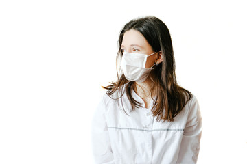 On a white background, a brunette woman in a white medical coat with gray accents and a protective...
