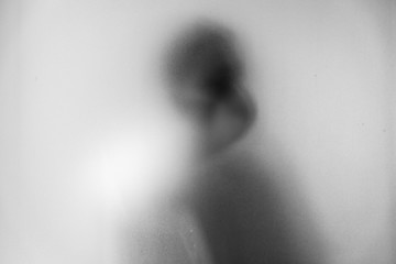 Obraz premium Shadow blur of man wear mask to prevent infection background.Fight against communicable diseases covid-19.Black and white picture.Blur picture.Fight deadly communicable diseases coronavirus.Soft focus