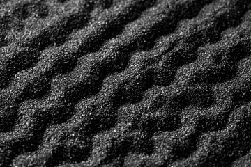 Naklejka na ściany i meble Black sand dunes background. Bump trace. Creative sand relief.