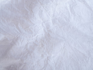 Abstract background texture with white wrinkled creased fabric.