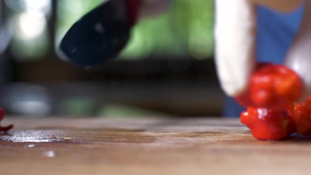 Chopping carolina reaper chillis in half