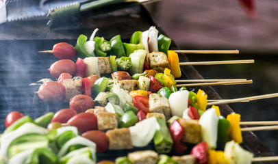 Colorful vegetables are grilled on a barbeque