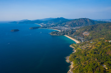Naklejka na ściany i meble Aerial view of the coastline of Phuket island with tropical sandy beaches and mountains at sunny day, Thailand