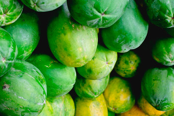 Closeup of freshly picked organic papaya fruit of Solo variety. It's also known as papaw or pawpaw. It contains papain enzyme which aids digestion and bowel movement. Selective focus. 