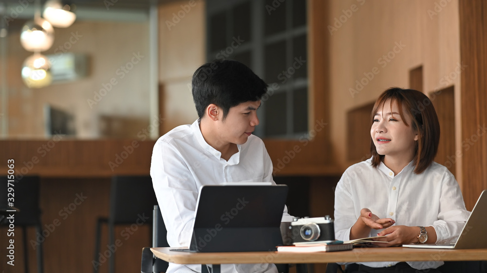 Poster photo of business development team working together with computer laptop and tablet while sitting at
