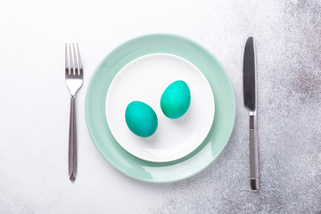 Spring easter table setting with silverware and eggs. Top view. Copy space