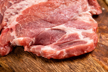 raw meat, pig neck on a wooden background