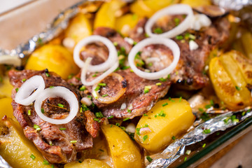baked in foil pork neck, potatoes and onion