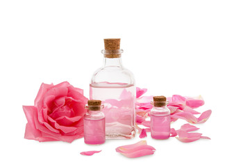 Rose flowers and rose oil in glass bottles isolated on white background, aromatherapy and SPA