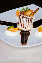 Creamy cheesecake with with syrup glazed fruits and whipped cream