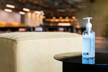 Clear alcohol gel pump bottle for use in hand washing placed on the table, prevent germs protect virus Covid-19, health care in office, meeting room or public space. Medical health protection.
