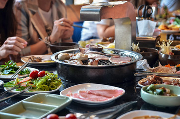 A variety of raw meat and sea products prepared on grill in asian restaurant. Selective focus.