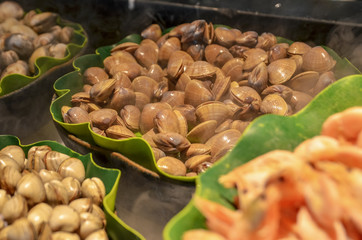 A variety of seafood sold outdoors in Chinese street market. Selective focus.