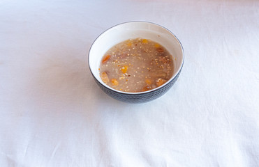 Traditional Turkish dessert ashure or Noah's Pudding with spoon on the table.