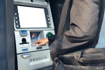 Close-up Of Person Using Credit Card To Withdrawing Money From Atm Machine