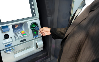 Man using his credit card in an atm for cash withdrawal