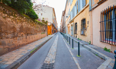 Narrow street with typical orange houses - Aix en Provence, France