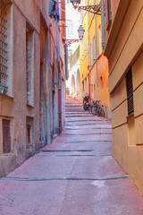 Fototapeta na wymiar Narrow street with typical orange houses - Nice, France
