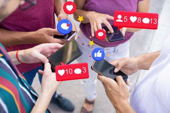 Team of colleagues standing in circle and using mobile phones. Men and woman using mobile app with social media notification icons. Teamwork concept - Powered by Adobe