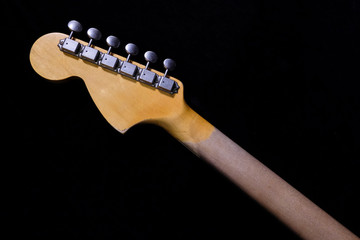 close up detail of electric guitar headstock, with selective focus.